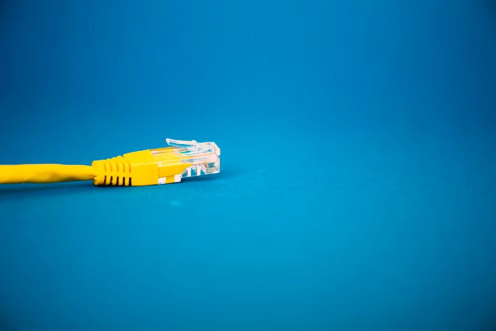 yellow LAN cable on blue background